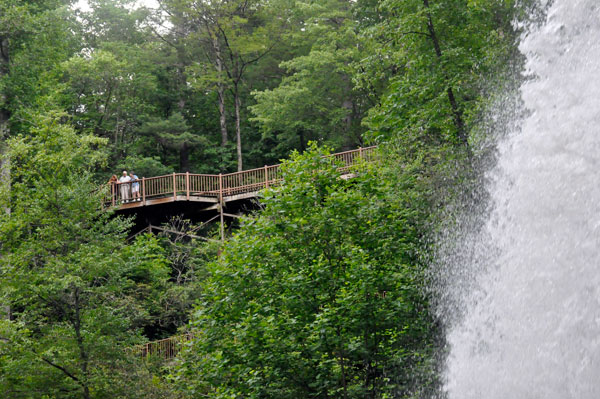 people on the two tiers of path and stairs leading to the falls.